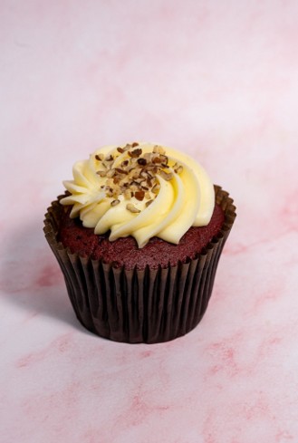 Smallcakes signature red velvet cupcake topped with cream cheese frosting